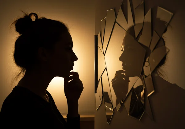 Woman reflecting, symbolizing self-discovery journey.